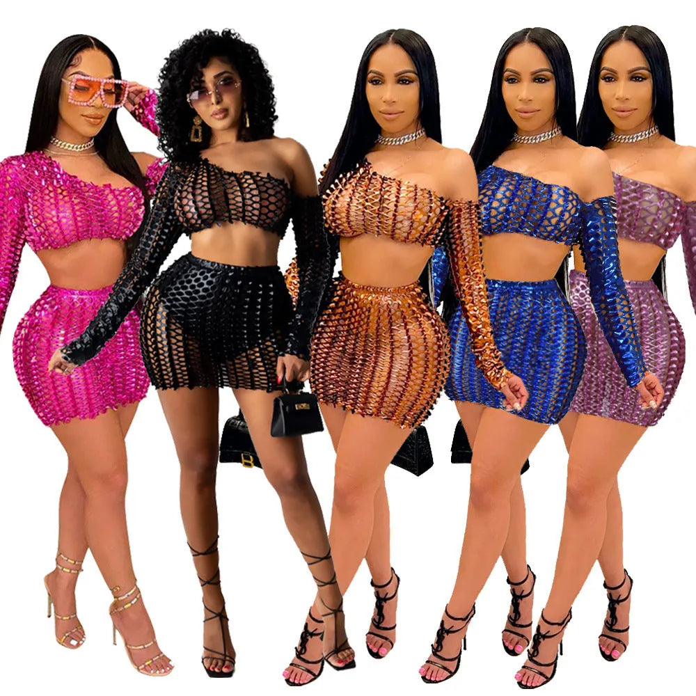 Women's black hollow-out net top and matching short skirt two-piece set on a model.
