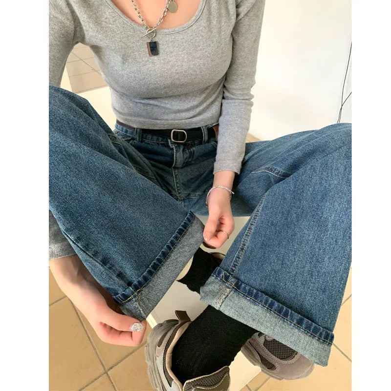 Women's retro blue high waist straight leg jeans laid flat, showing the five-pocket design and button fly.