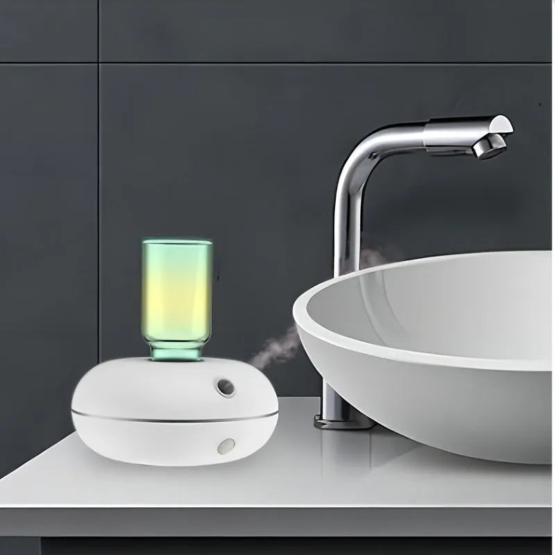 Automatic sensor fragrance machine mini USB home indoor air diffuser inverted aromatherapy in white colour on bathroom counter.