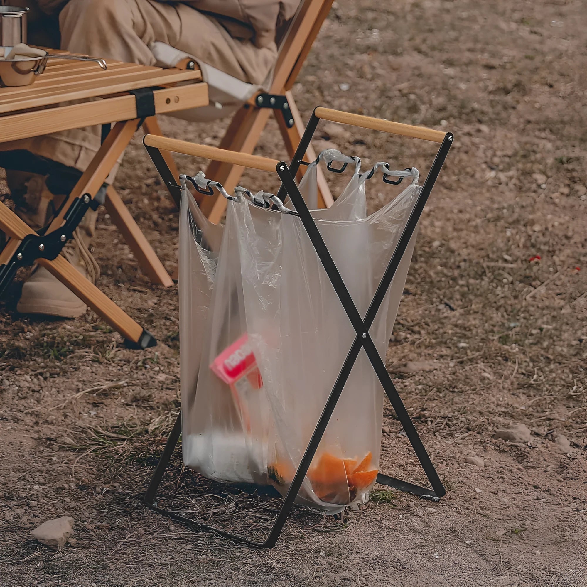 Foldable outdoor garbage storage hanger with iron frame and wooden handle in black colour.