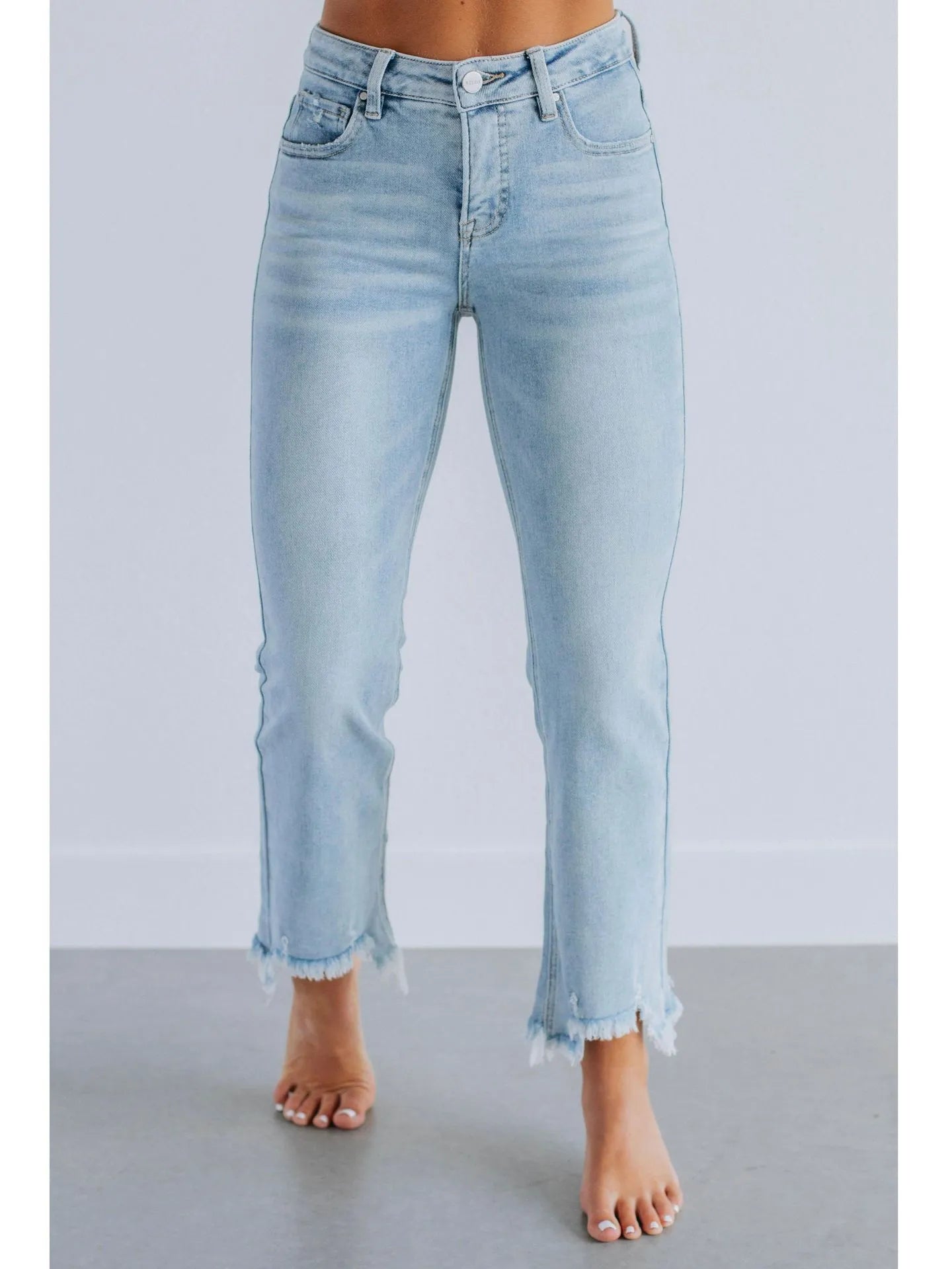 Women's solid colour denim jeans with a hand-worn distressed finish in dark blue.