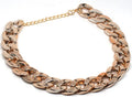 Gold chain dog collar with geometric plastic and resin ornaments on small dog neck