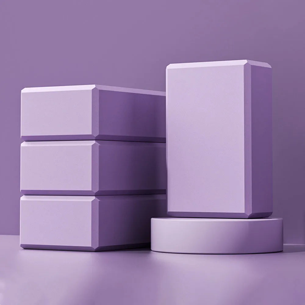 Solid colour EVA foam yoga block showing hexagonal facets with ridges, measuring 23x15x7.6cm