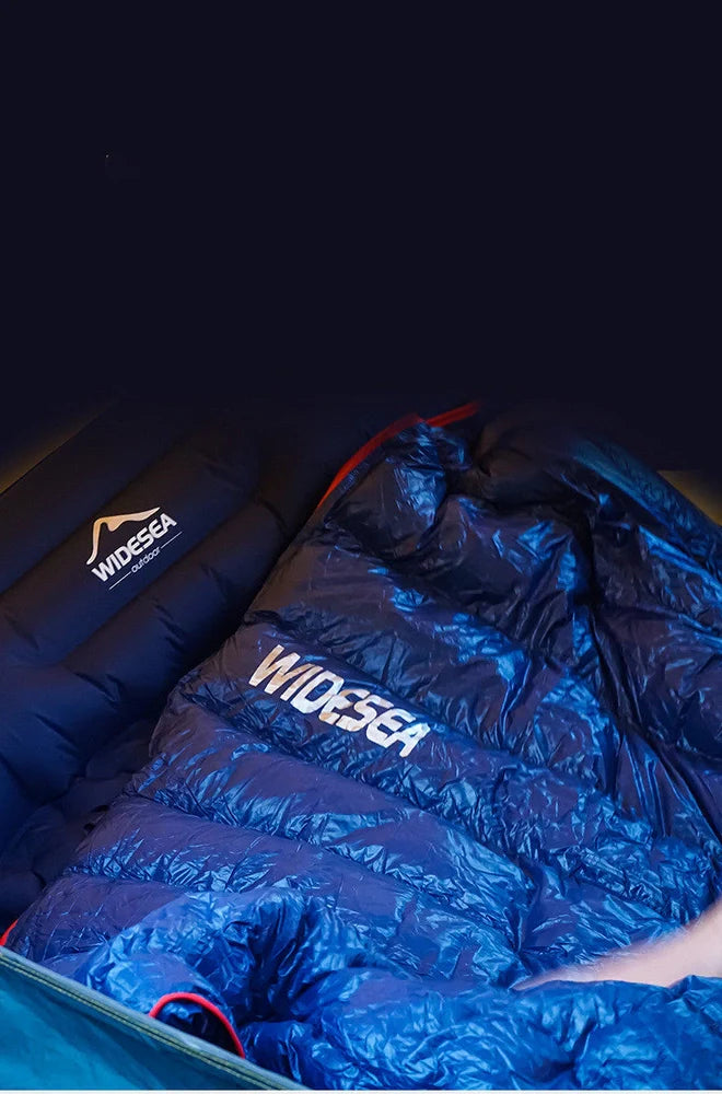 Cyan grey camping sleeping bag with compression sack showing 90% white duck down filling and waterproof nylon fabric