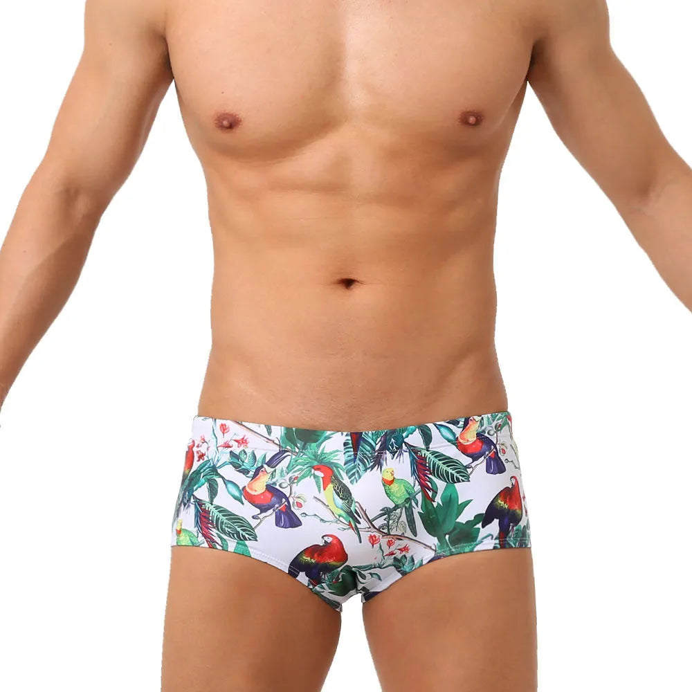 Men's floral bird print swim trunks with cup compartment in blue and white design