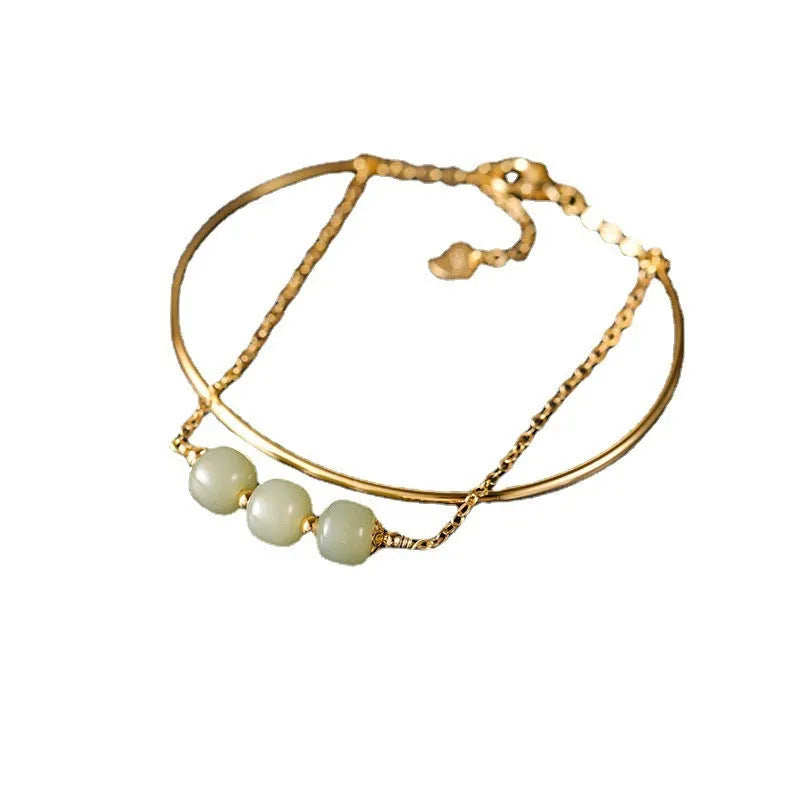 Women's jade bracelet with gold inlay detailing showing single bead version