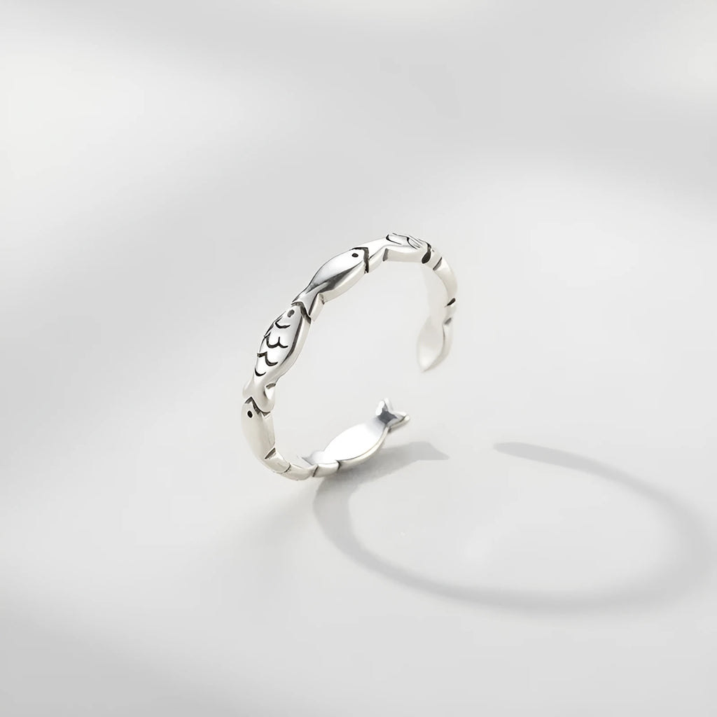 Close-up of a women's adjustable S925 sterling silver ring featuring a detailed fish (carp) design.