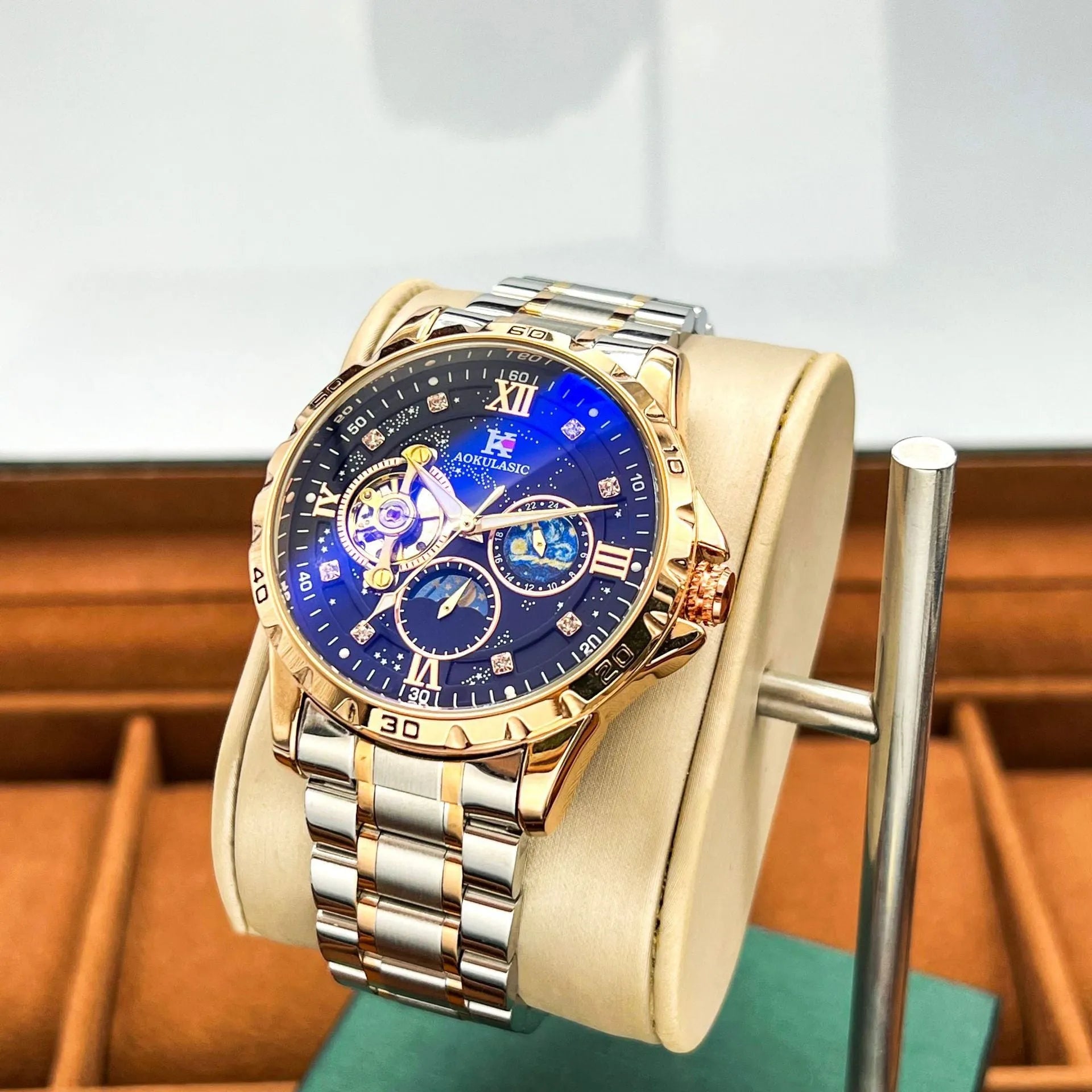 Automatic mechanical men's watch with rose gold case, black dial, and large day-date display.