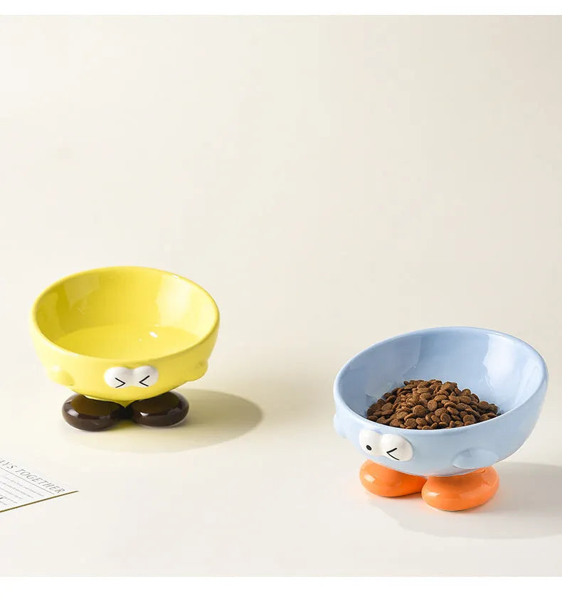 Blue tall ceramic pet food bowl with oblique shape and a silicone non-slip ring on the base.