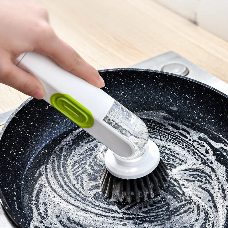 White and red long-handle kitchen cleaning brush with integrated soap dispenser button and two brush heads.