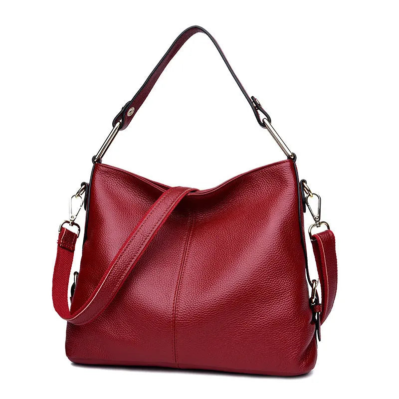 Genuine leather vertical square crossbody bag in black with multiple internal organiser pockets.