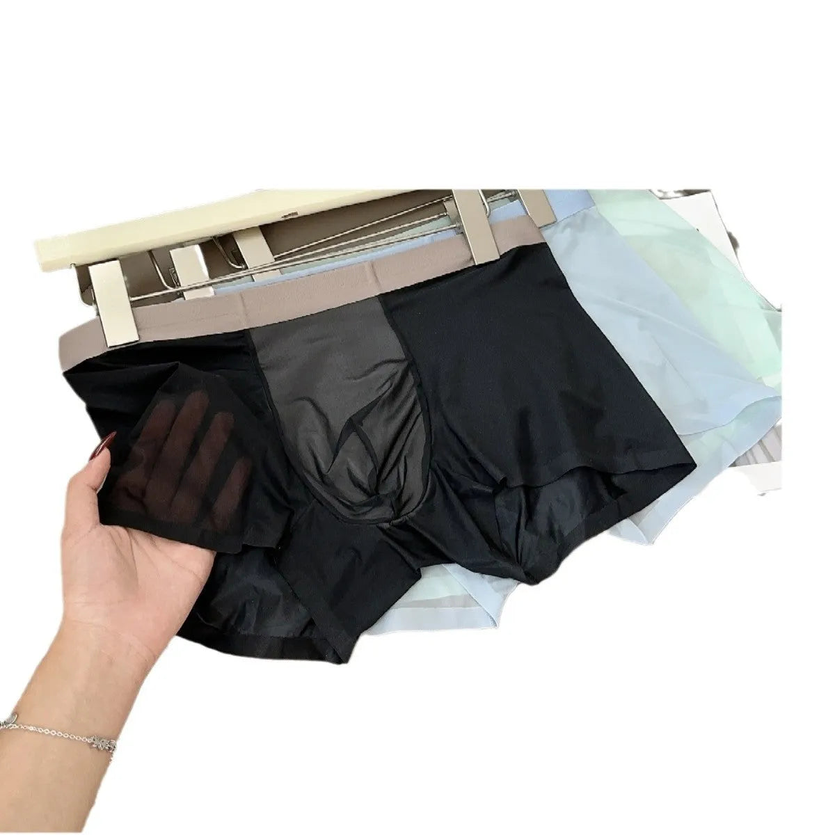 Ultra-thin Ice Silk seamless men's boxer shorts on a mid waist, showing honeycomb crotch detail.