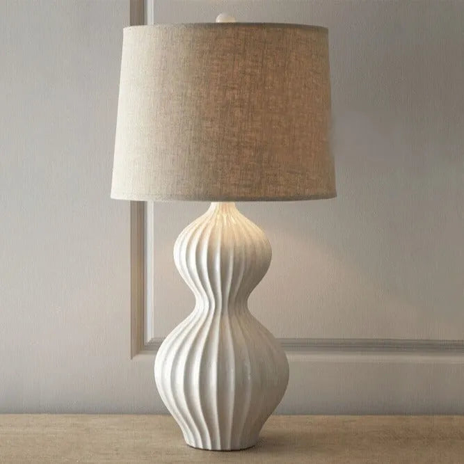 Ceramic base table lamp with a white fabric shade in an American simple country style.