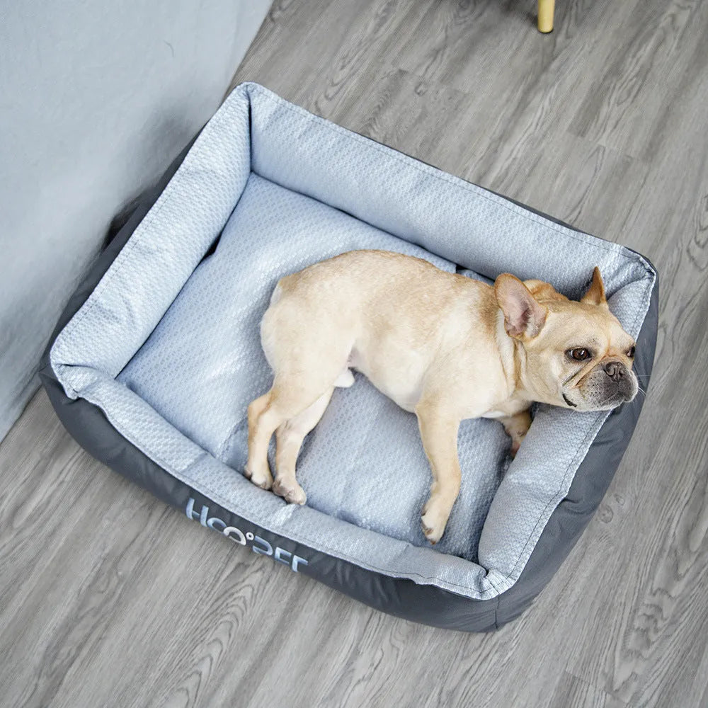 Soft grey dog bed with raised edges and a removable plush cover, shown in medium size.