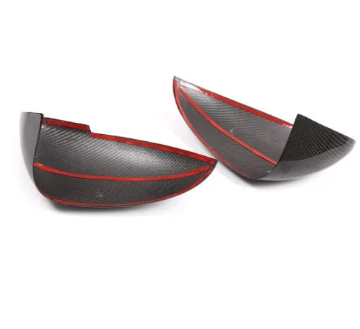 True carbon fibre exterior mirror covers for a Porsche Macan, shown in high-gloss black.