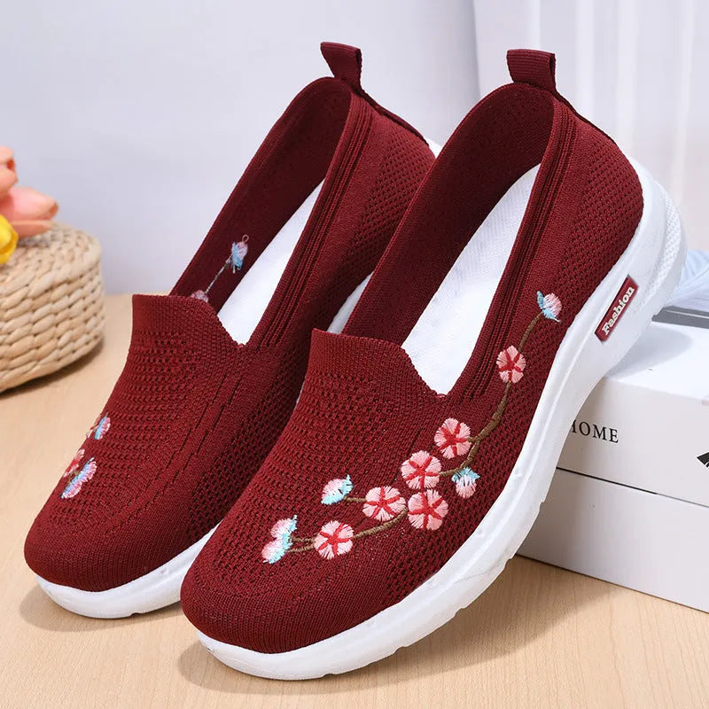 Women's embroidered flywoven casual flat pumps in wine red, shown on a white background.