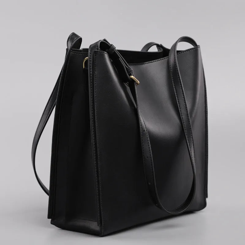 Brown genuine leather women's bucket handbag with double shoulder straps and interior organisation pockets