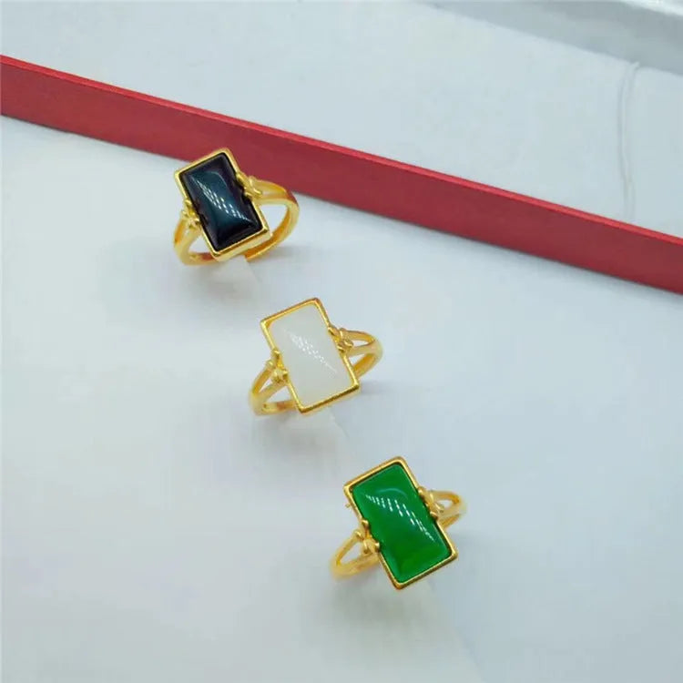 Adjustable brass gold-plated ring with a green gemstone set in a national style design.