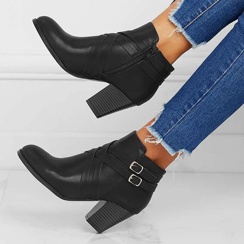 Women's grey ankle boot with 7cm block heel, side zipper, and buckle detail on a plain toe.