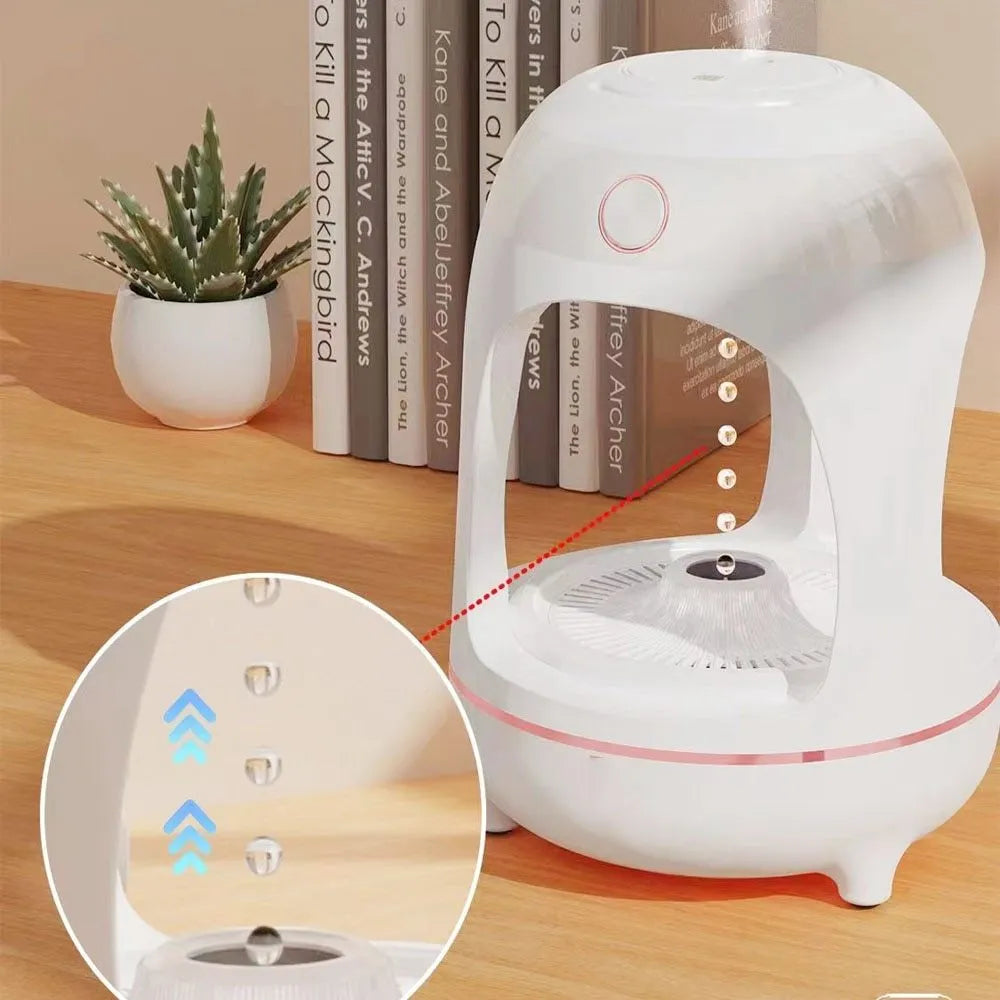 Rose gold and white columnar humidifier with levitating water drops and LED glow on a desk