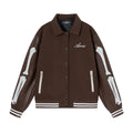 Women's apricot jacket with bone embroidery detail on the front, shown on a hanger.