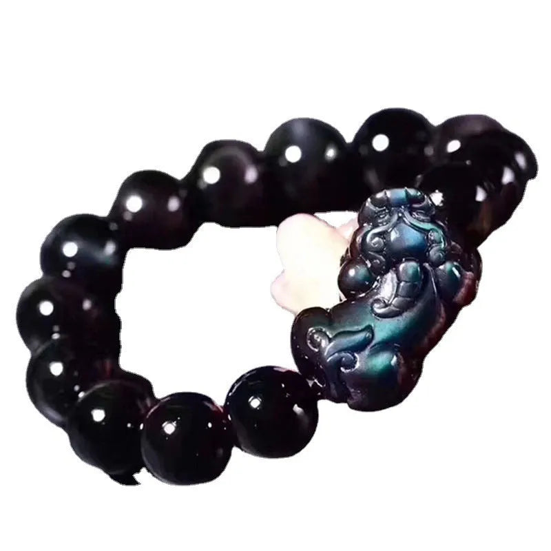 Natural Ice Obsidian beaded bracelet on wrist showing pale crystal beads.