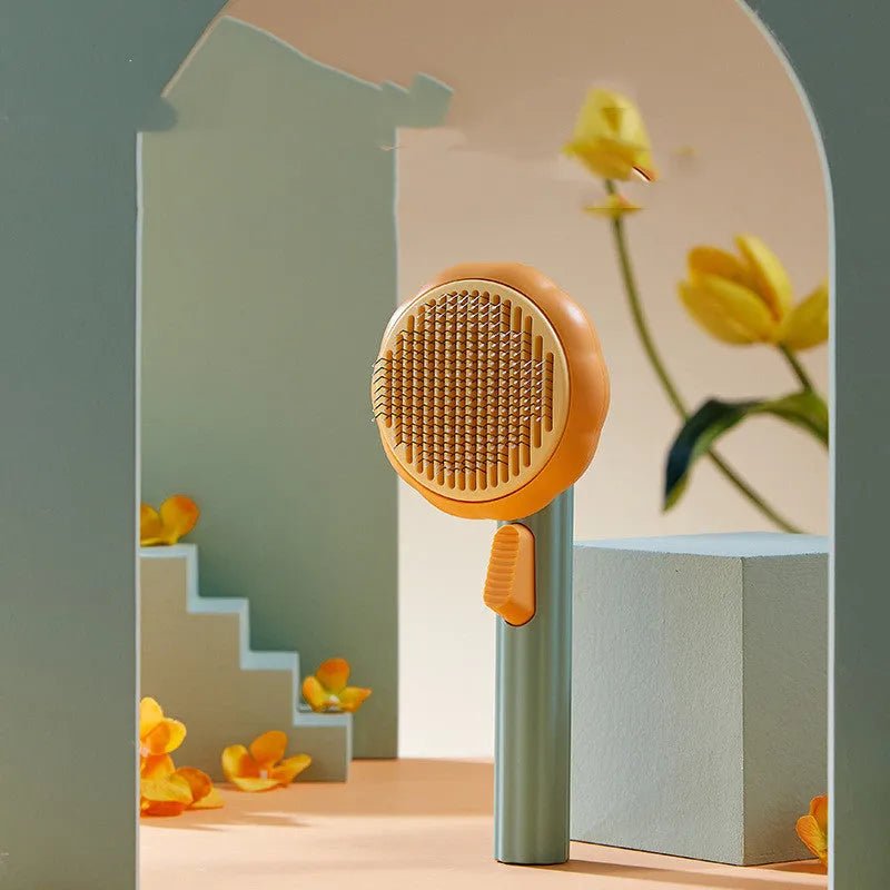 Pumpkin coloured pet grooming brush with curved stainless steel needles for hair removal