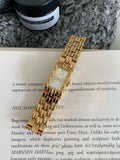 A bracelet-style ladies' watch with a stainless steel case, showing a choice of silver or gold finishes with white or grey dials.
