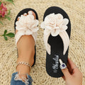 Casual beige flip-flops with a floral pattern on the straps and a light-coloured EVA sole.