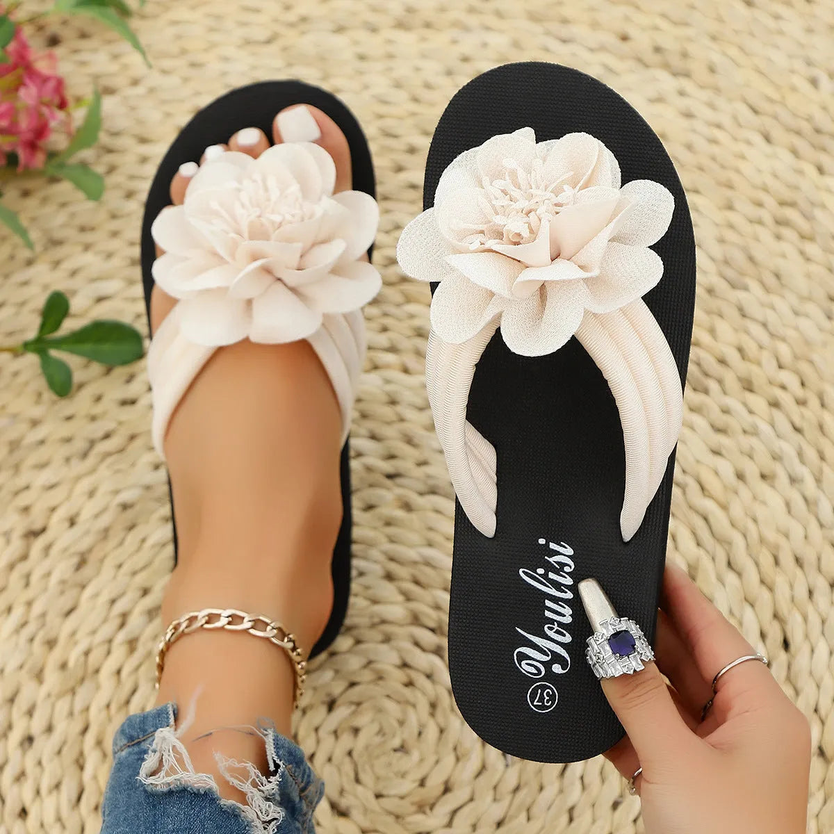 Casual beige flip-flops with a floral pattern on the straps and a light-coloured EVA sole.