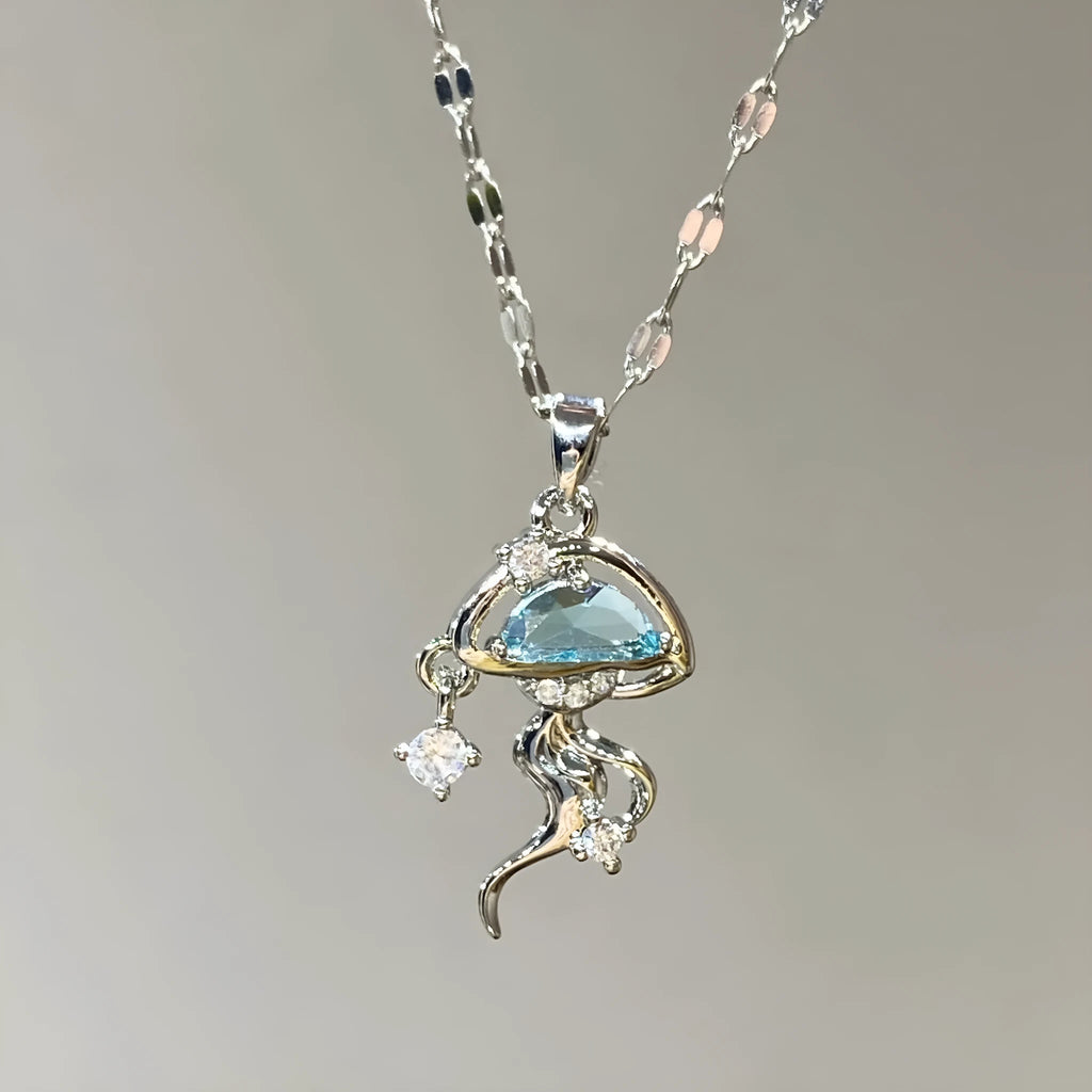 Blue jellyfish pendant on a white gold coloured adjustable sterling silver necklace chain.