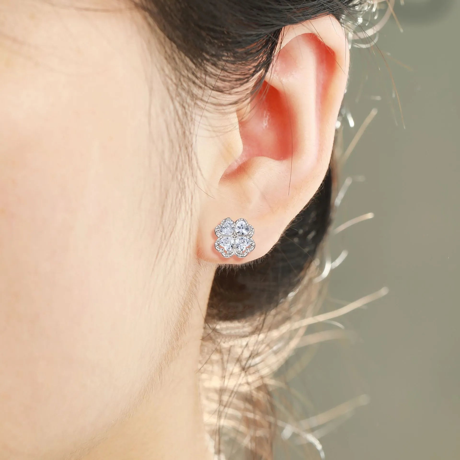Women's sterling silver heart-shaped earrings with a four-leaf clover design and zircon stones.