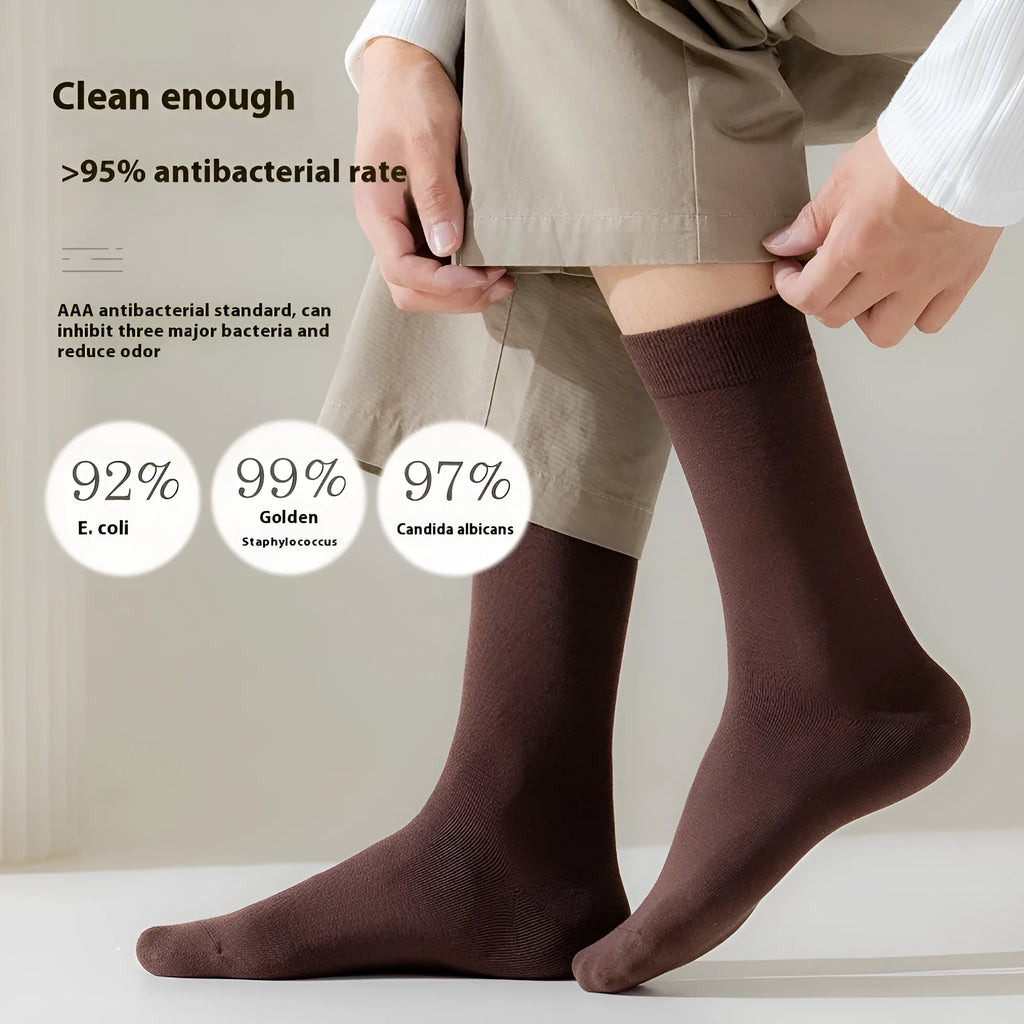 Men's mid-calf business socks in pure combed cotton showing solid colour options including army green, beige, black, and grey