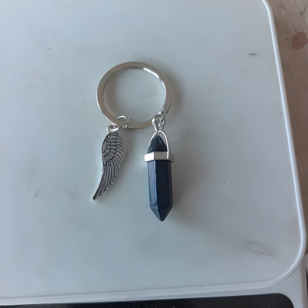 Natural stone bag hanging ornament pendant with metal key ring on a blue background