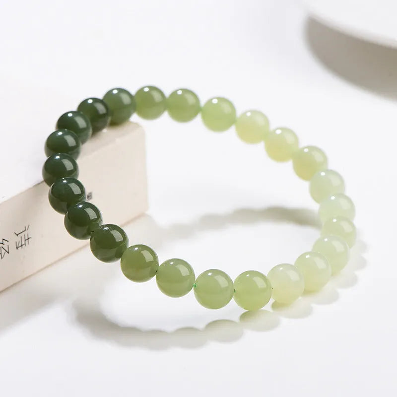 Natural Hetian jade bracelet with gradient water colour round beads on a wrist