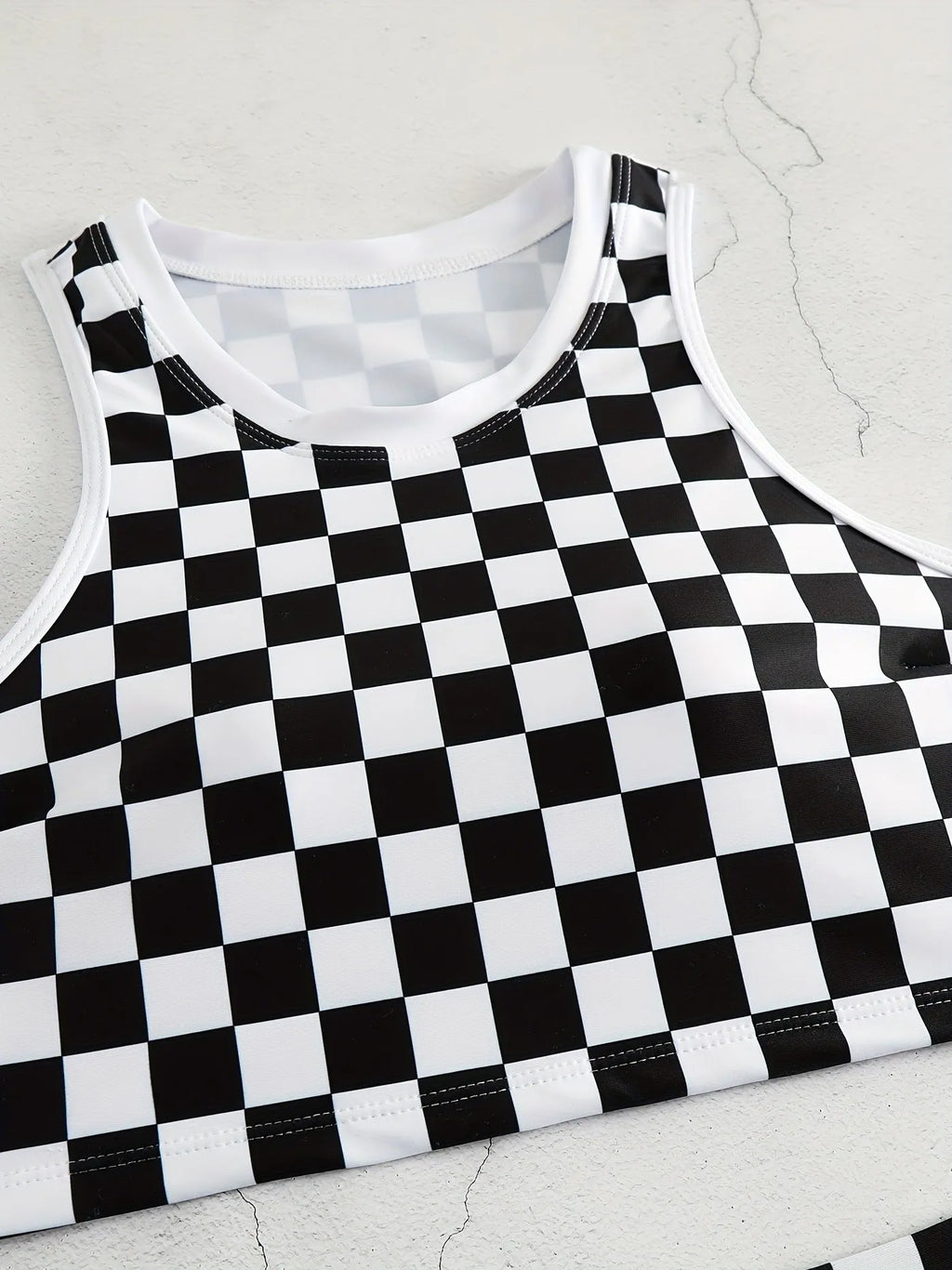 Women's black and white chessboard plaid racing one-piece swimsuit with a suspender backless design.
