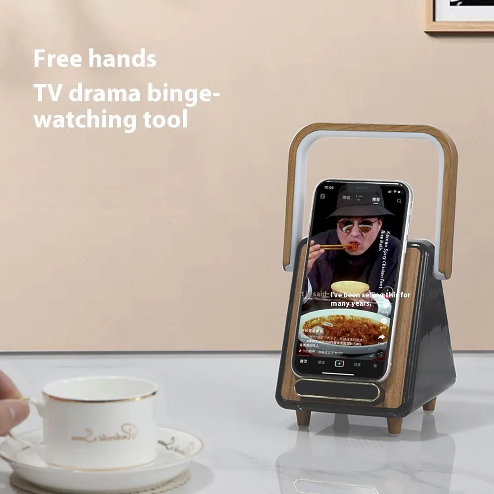 Wireless charging induction Bluetooth speaker small night lamp in Platinum Jazz finish with USB cable on a wooden desk