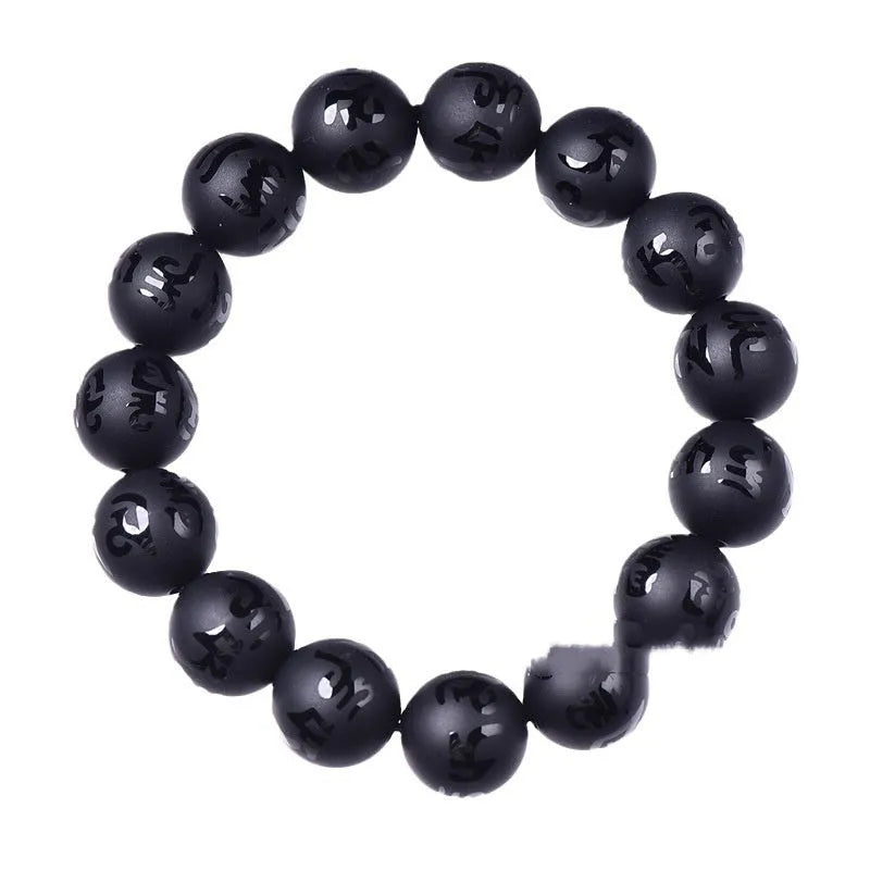 Natural frosted black agate Sanskrit mantra bracelet with Chinese style auspicious patterns on a wrist.