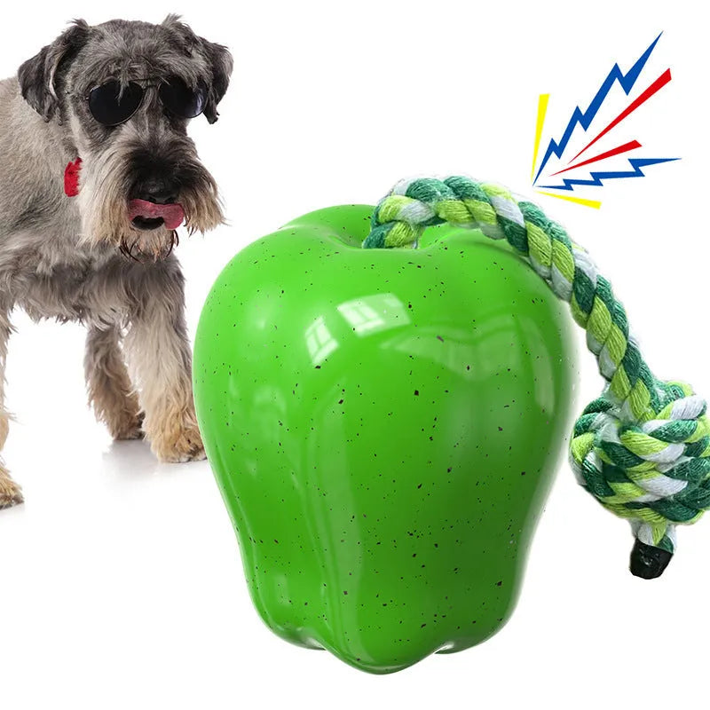 Green apple-shaped plastic dog toy with textured surface and hollow treat-dispensing centre