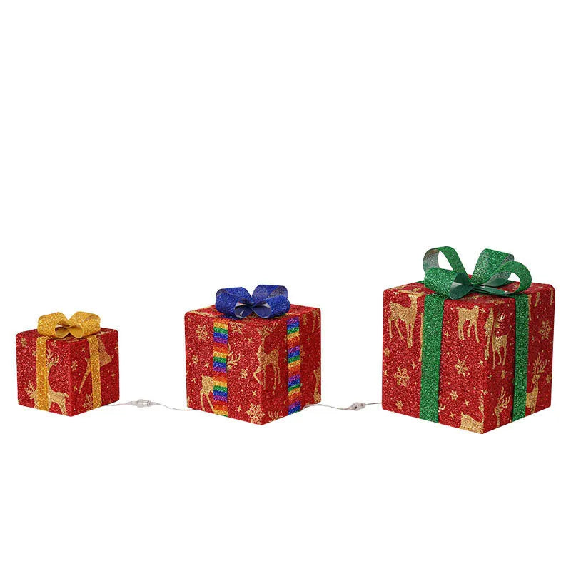 Set of three lighted Christmas gift box decorations with bows and LED lights for outdoor holiday decor