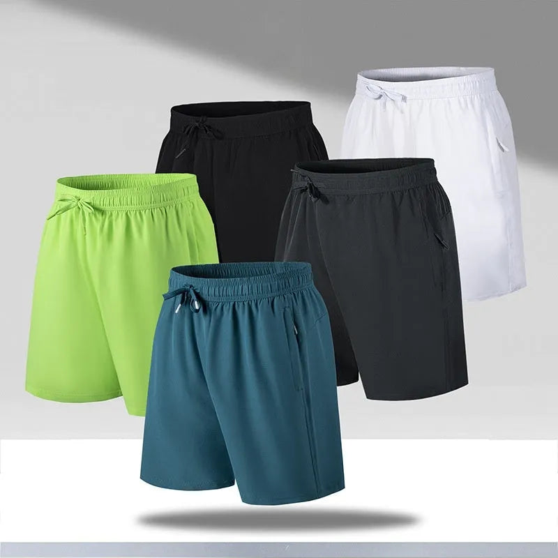 Man wearing loose-fitting quick-dry polyester sports shorts on a beach.
