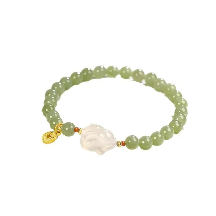 Handmade Hetian jade rabbit bracelet for women in glass with sweet rabbit charm on wrist.