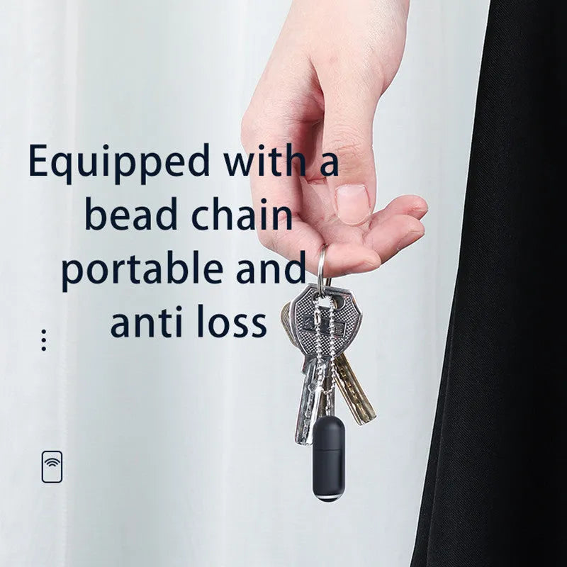Black capsule-shaped infrared emitter for smartphone remote control.