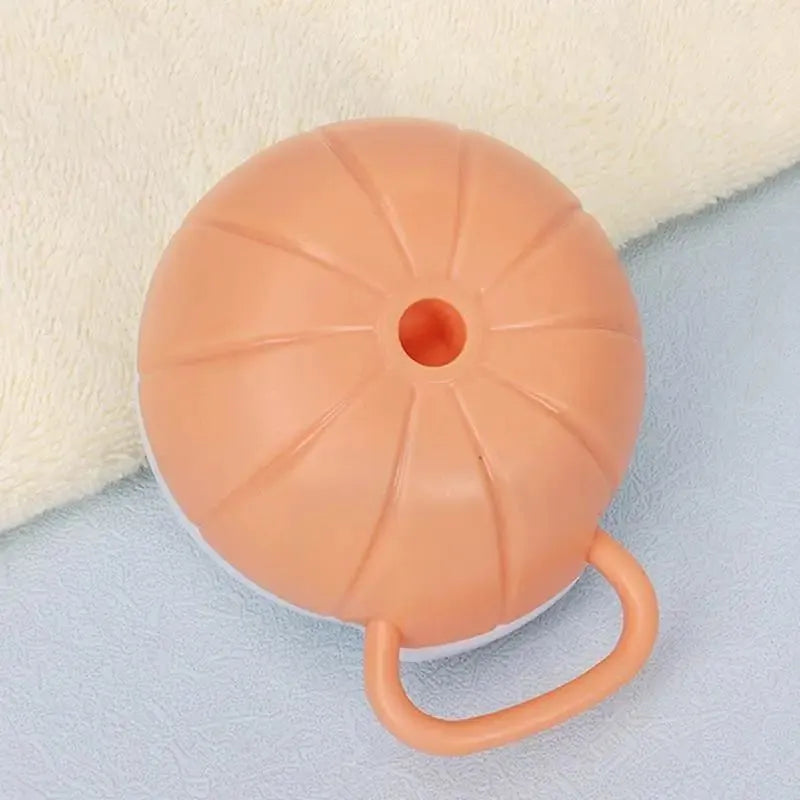Orange dog bath brush with shampoo dispenser and soft TPR bristles for pet grooming