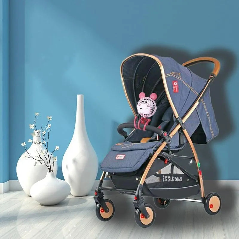 Cute animal design mini stroller fan with LED night light and flexible clip in pink on a stroller