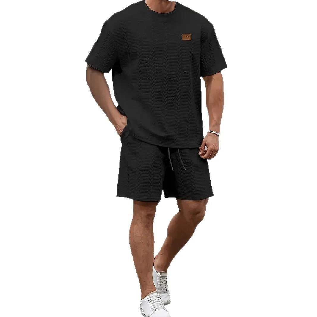 Men's black sports two-piece set with ribbed short sleeves and matching shorts