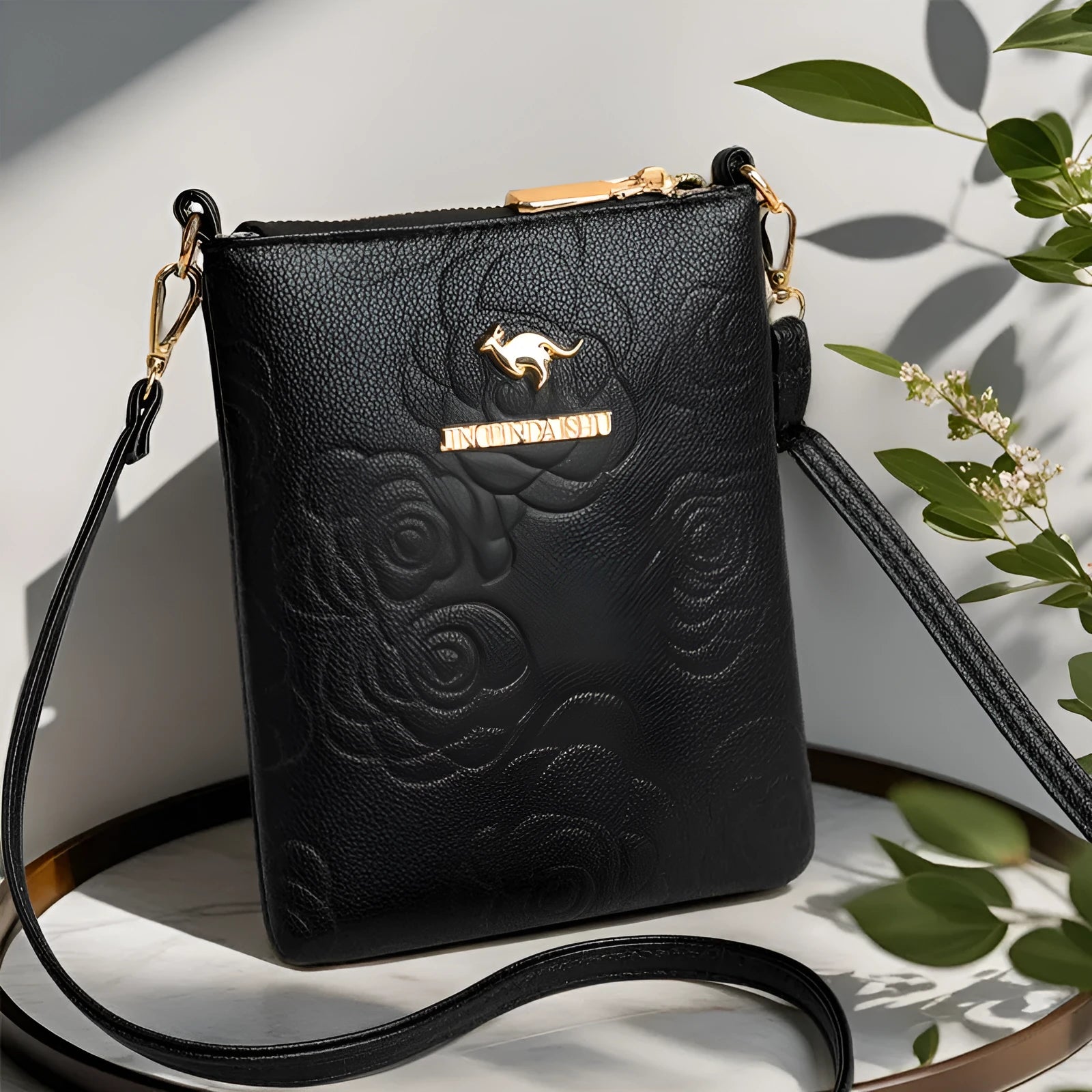 Soft square black PU leather shoulder messenger bag with visible sewing thread detail and outer pocket