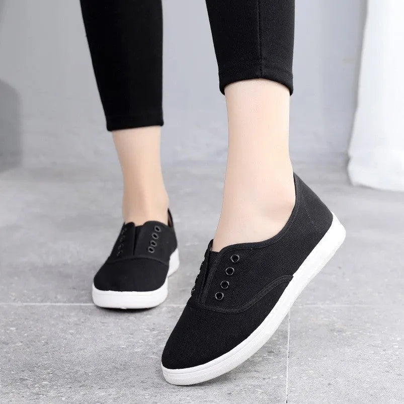 Low-top canvas trainers in black, white, grey and pink colours with plastic sole