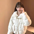 Beige cotton-padded coat with fur collar, dot pattern, and front pockets on a model