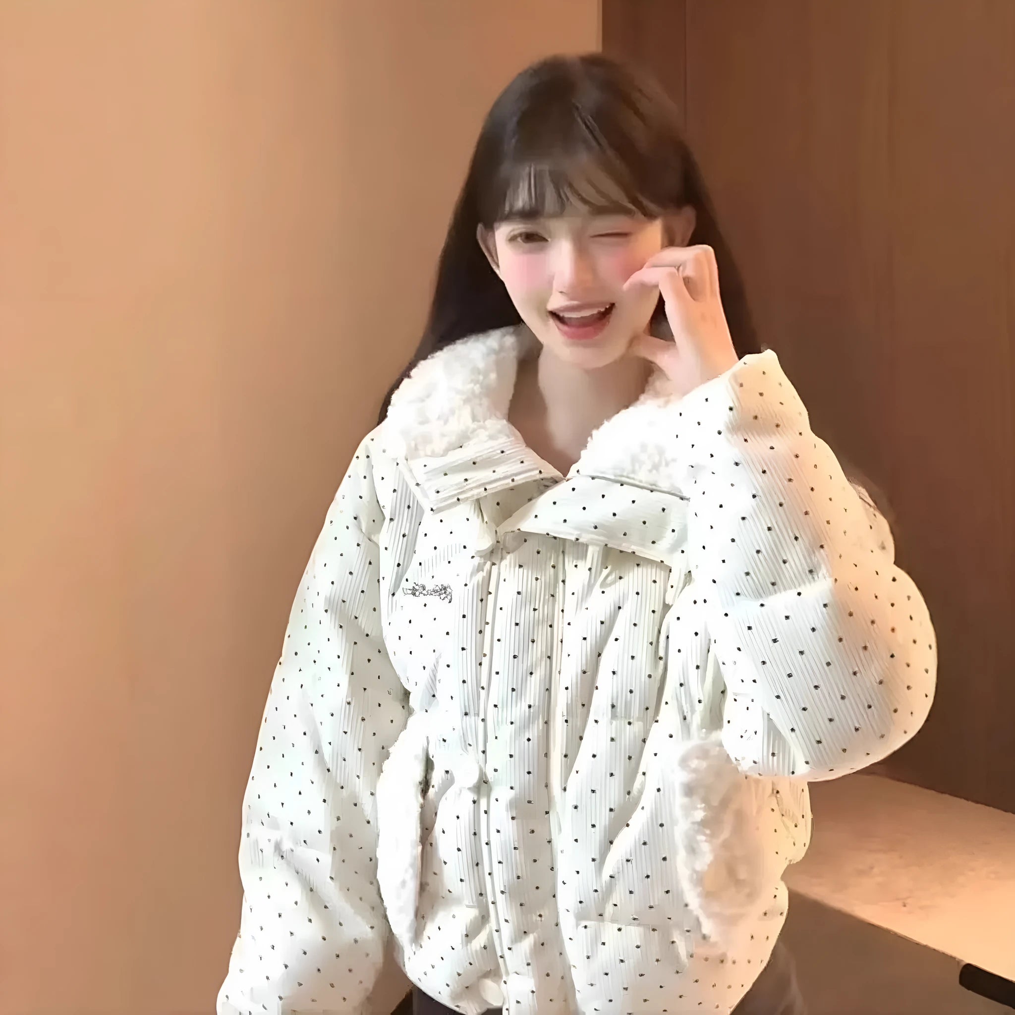 Beige cotton-padded coat with fur collar, dot pattern, and front pockets on a model